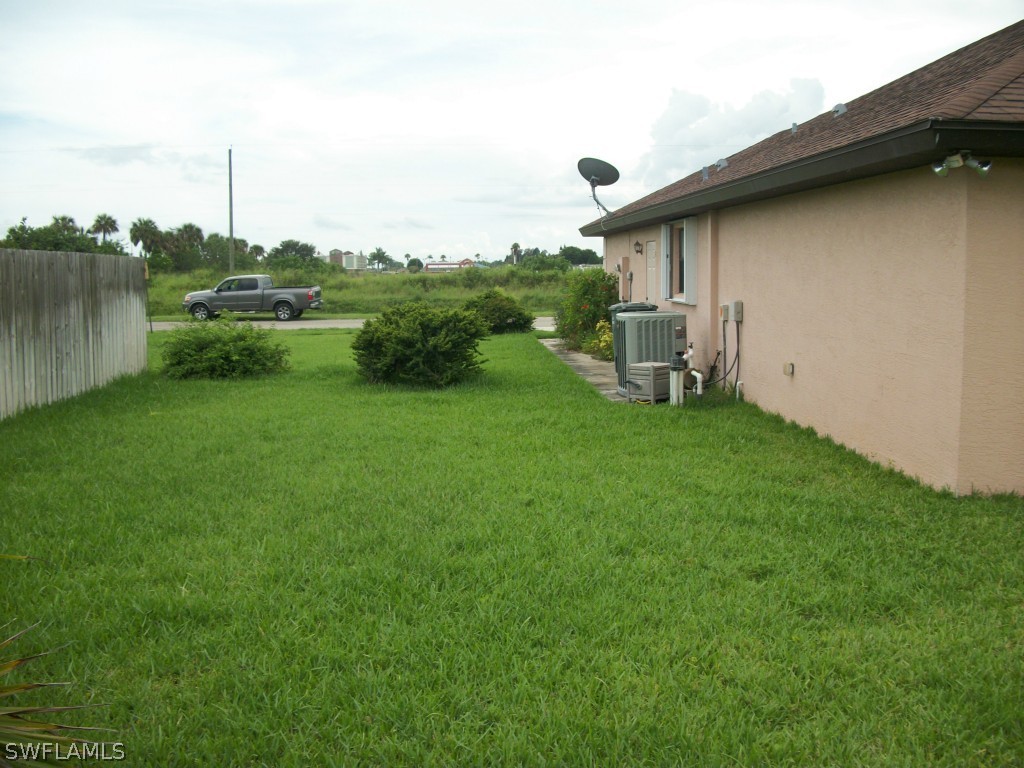 1019 Caribbean Avenue Clewiston, FL 33440 - Photo 16 of 16 a view of a chair and table on the green field