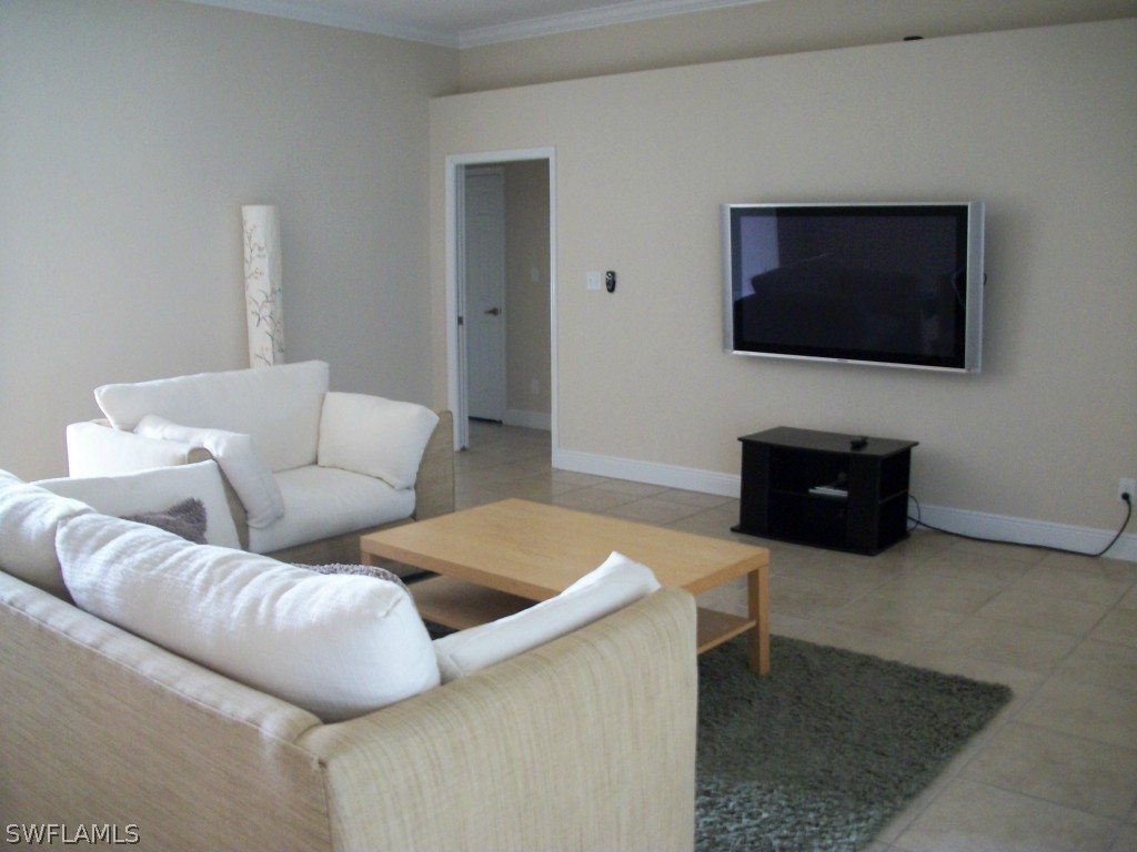 1019 Caribbean Avenue Clewiston, FL 33440 - Photo 7 of 16 a living room with furniture and a flat screen tv
