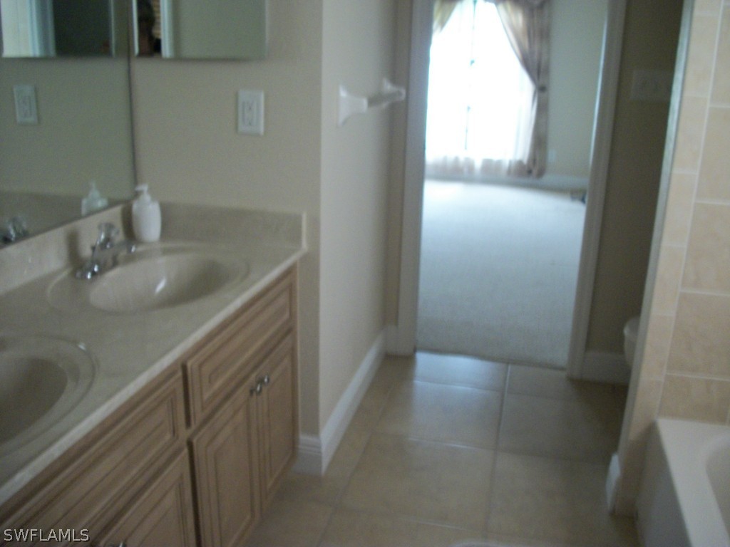 1019 Caribbean Avenue Clewiston, FL 33440 - Photo 9 of 16 a bathroom with a granite countertop sink and a mirror