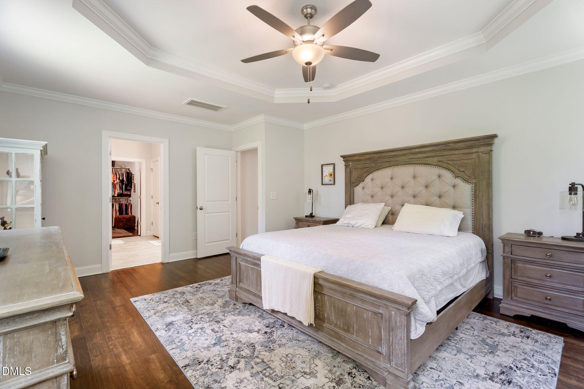223 Colonial Ridge Drive Pittsboro, NC 27312 - Photo 18 of 47 a spacious bedroom with a large bed and a chandelier