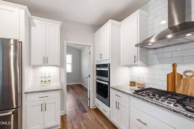 a living room with furniture a chandelier and a fireplace