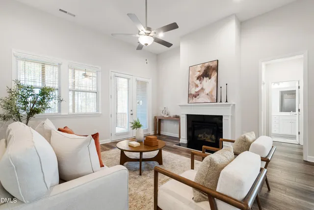 a dining room with furniture a chandelier and wooden floor