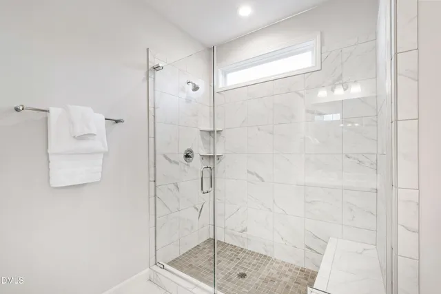 an empty room with a ceiling fan and a window