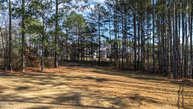 a backyard of a house with barbeque oven table and chairs