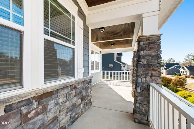 a kitchen with sink stove and white cabinets with wooden floor
