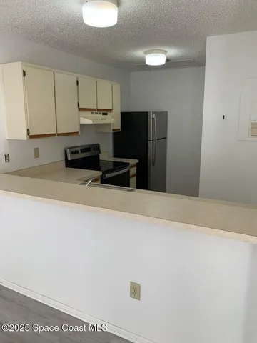 a kitchen with stainless steel appliances a refrigerator sink and cabinets