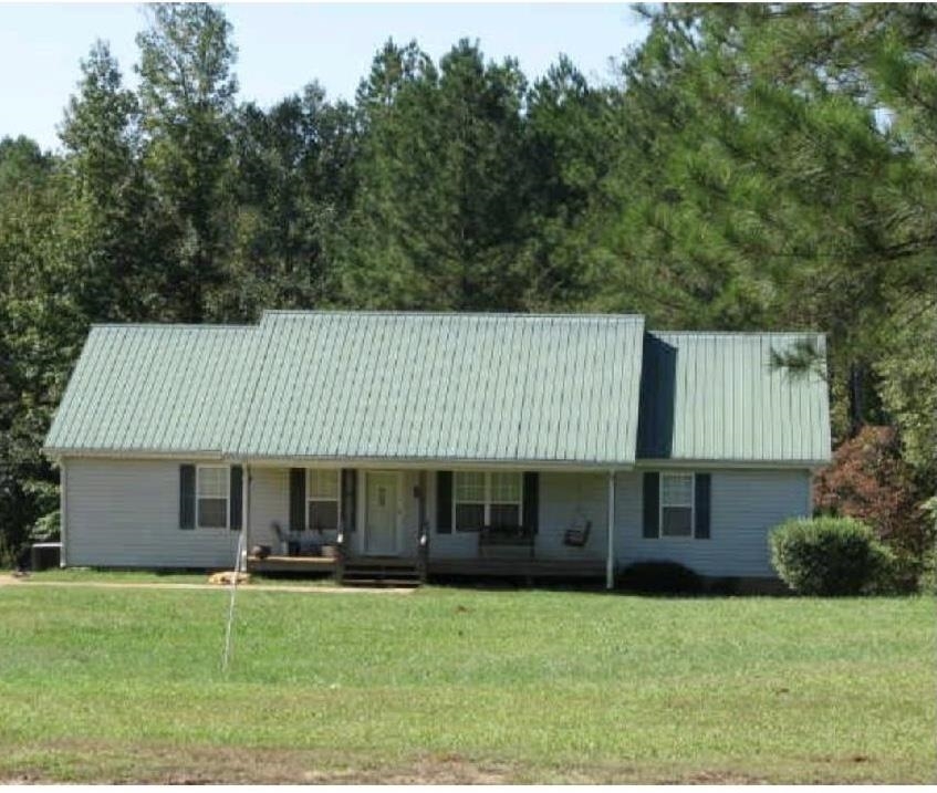 4111 5 Notch Road Franklin, GA 30217 - Photo 1 of 1 a front view of a house with a garden and porch