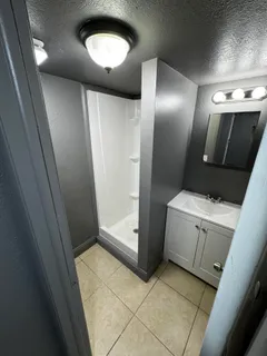 a view of backyard with wooden fence