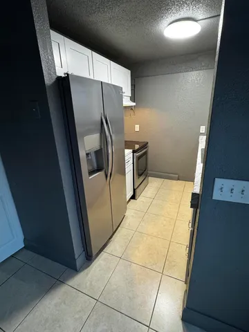 a view of a refrigerator in a kitchen