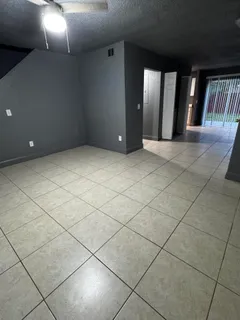 a view of a livingroom with an empty space and a window