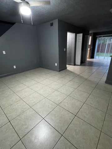 a view of a livingroom with an empty space and a window