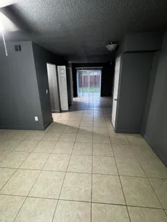 a view of a hallway with entryway of a kitchen