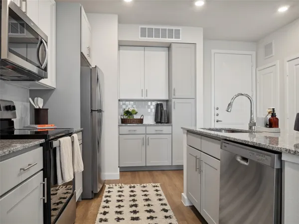 a kitchen with a sink stove and refrigerator