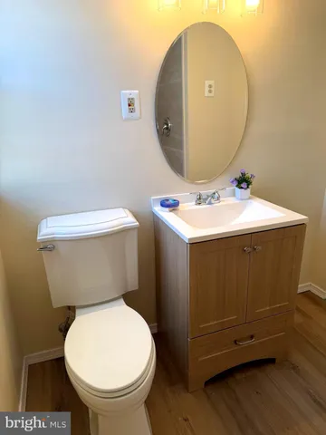 a bathroom with a toilet a sink and a mirror