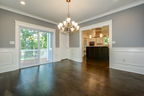 234 Langley Road Newton, MA 02459 - Photo 11 of 25 a view of a livingroom with a chandelier wooden floor and a chandelier