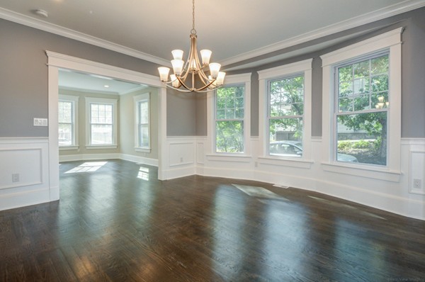 234 Langley Road Newton, MA 02459 - Photo 12 of 25 a view of a room with wooden floor chandelier and windows