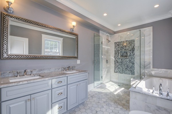 234 Langley Road Newton, MA 02459 - Photo 18 of 25 a spacious bathroom with double vanity sink a mirror and a shower