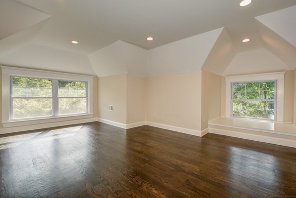 234 Langley Road Newton, MA 02459 - Photo 19 of 25 an empty room with wooden floor and windows