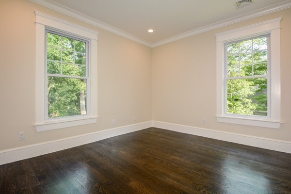 234 Langley Road Newton, MA 02459 - Photo 20 of 25 an empty room with wooden floor and windows