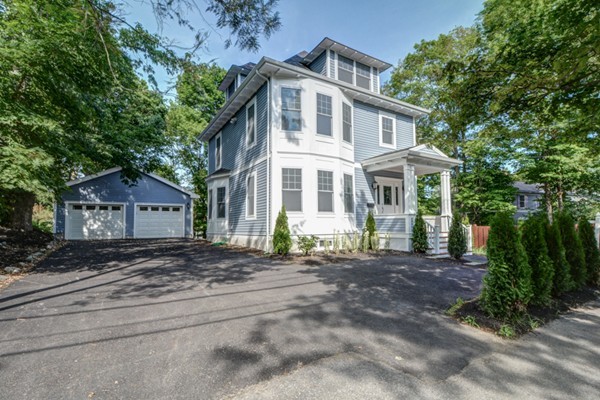 234 Langley Road Newton, MA 02459 - Photo 2 of 25 a front view of a house with a garden