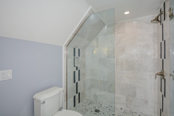 234 Langley Road Newton, MA 02459 - Photo 22 of 25 a bathroom with a shower a toilet and sink