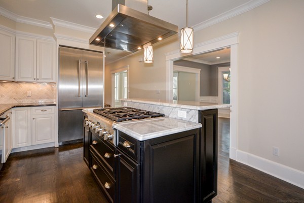 234 Langley Road Newton, MA 02459 - Photo 6 of 25 a kitchen with a stove and a wooden floor
