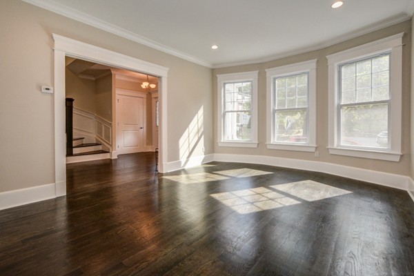 234 Langley Road Newton, MA 02459 - Photo 9 of 25 a view of an empty room with wooden floor and a window