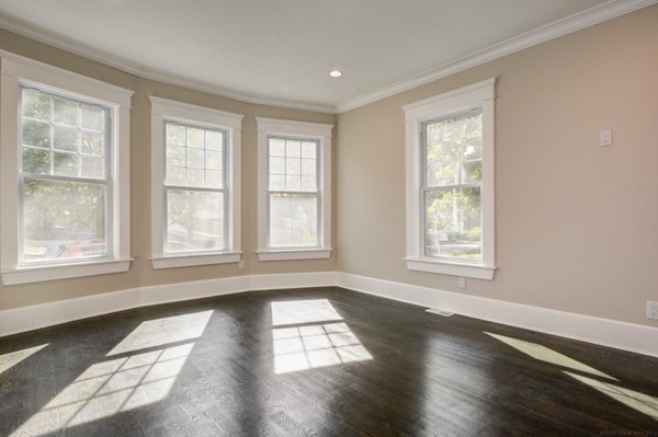 234 Langley Road Newton, MA 02459 - Photo 10 of 25 a view of an empty room with wooden floor and a window