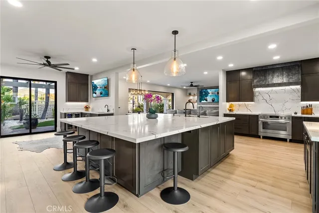 a kitchen with a sink a counter space appliances and cabinets