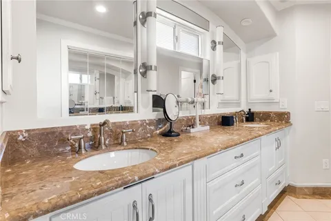 a bathroom with double sink and a mirror