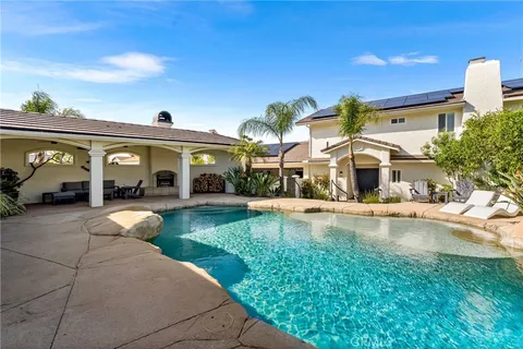 a front view of house with yard and outdoor seating