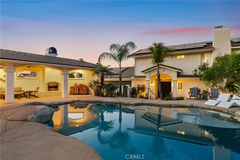a view of swimming pool with outdoor seating