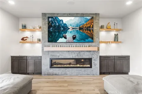 a bedroom with a fireplace and a wooden floor