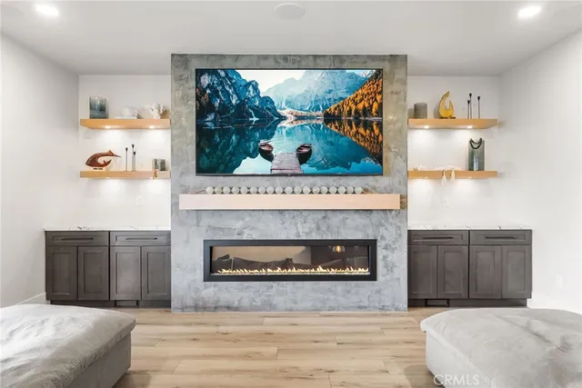 a bedroom with a fireplace and a wooden floor