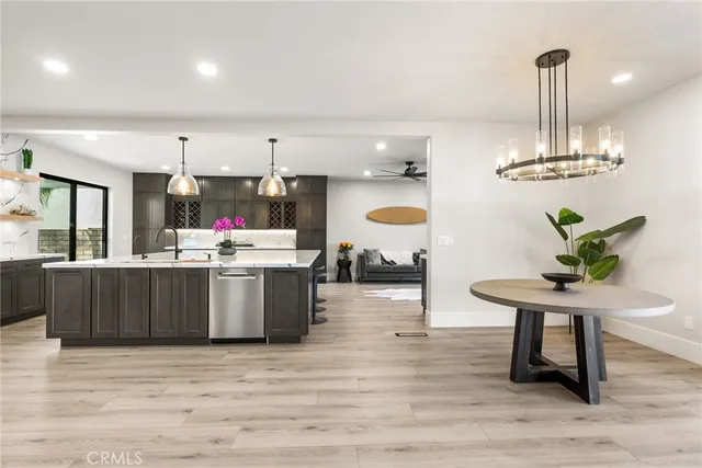 a kitchen with a sink cabinets and wooden floor