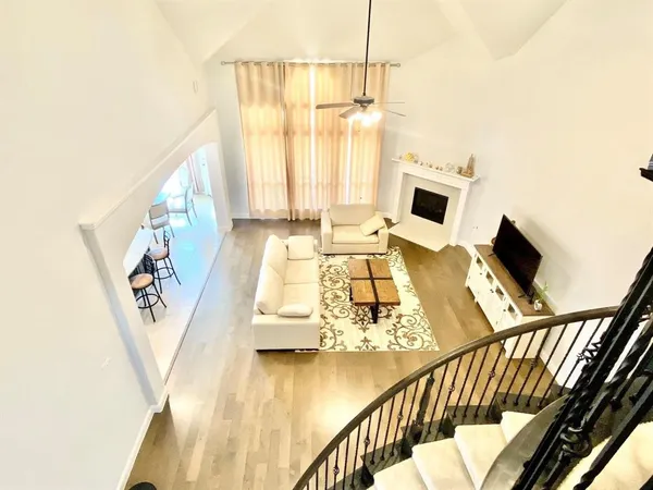 a view of a living room with furniture and a floor to ceiling window