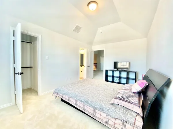 a bedroom with a bed and window