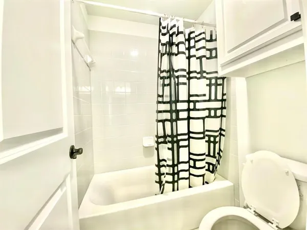 a bathroom with a bathtub and shower