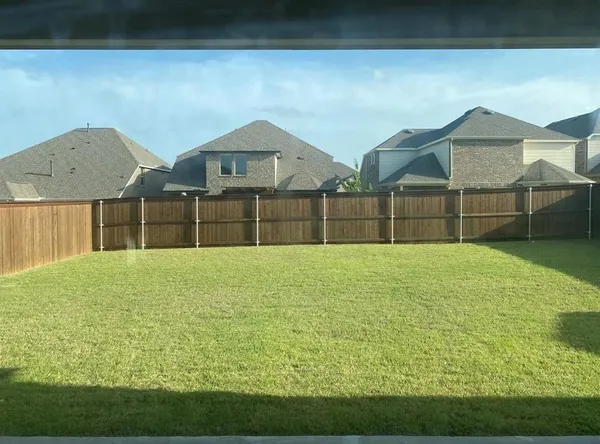 a house view with wooden fence