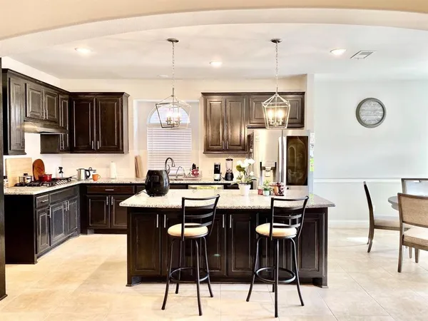 a kitchen with stainless steel appliances kitchen island granite countertop a sink and cabinets