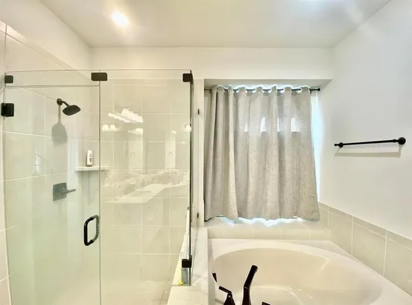 a bathroom with a tub and shower
