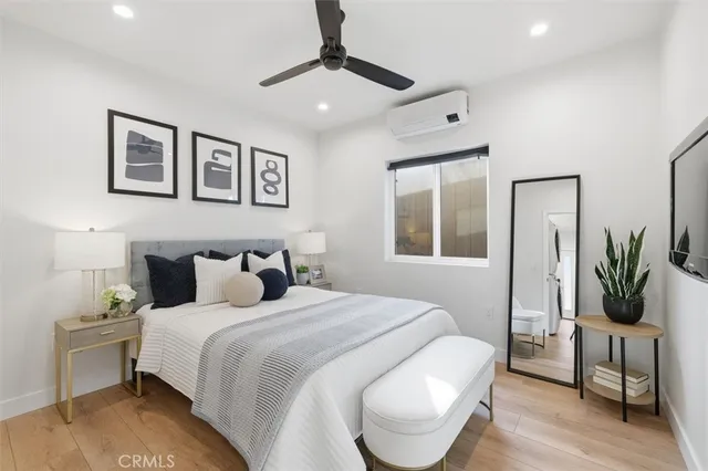 a bedroom with a bed and a potted plant