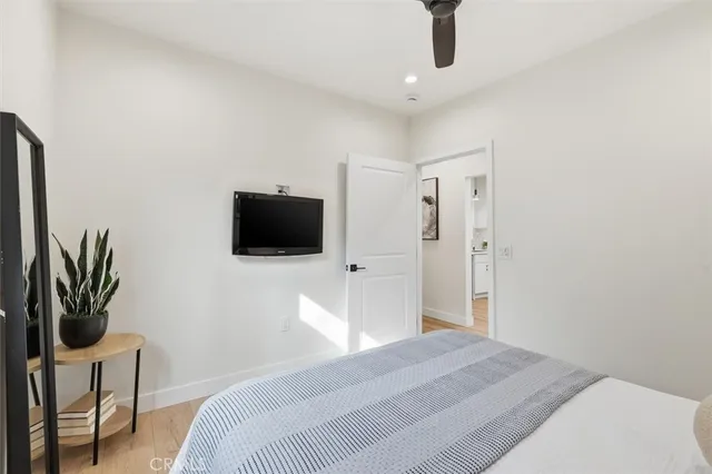 a bedroom with a bed and a television