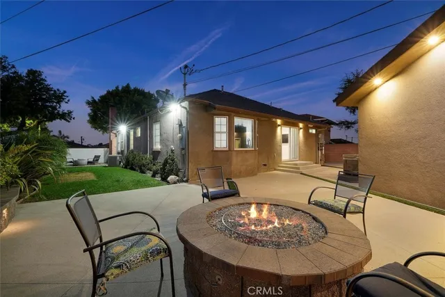 a dinning table and chairs in patio of a house