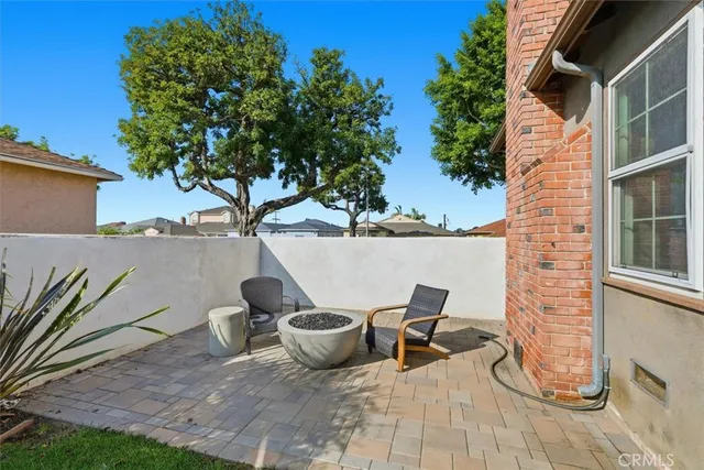 a view of a patio with chairs and potted plants