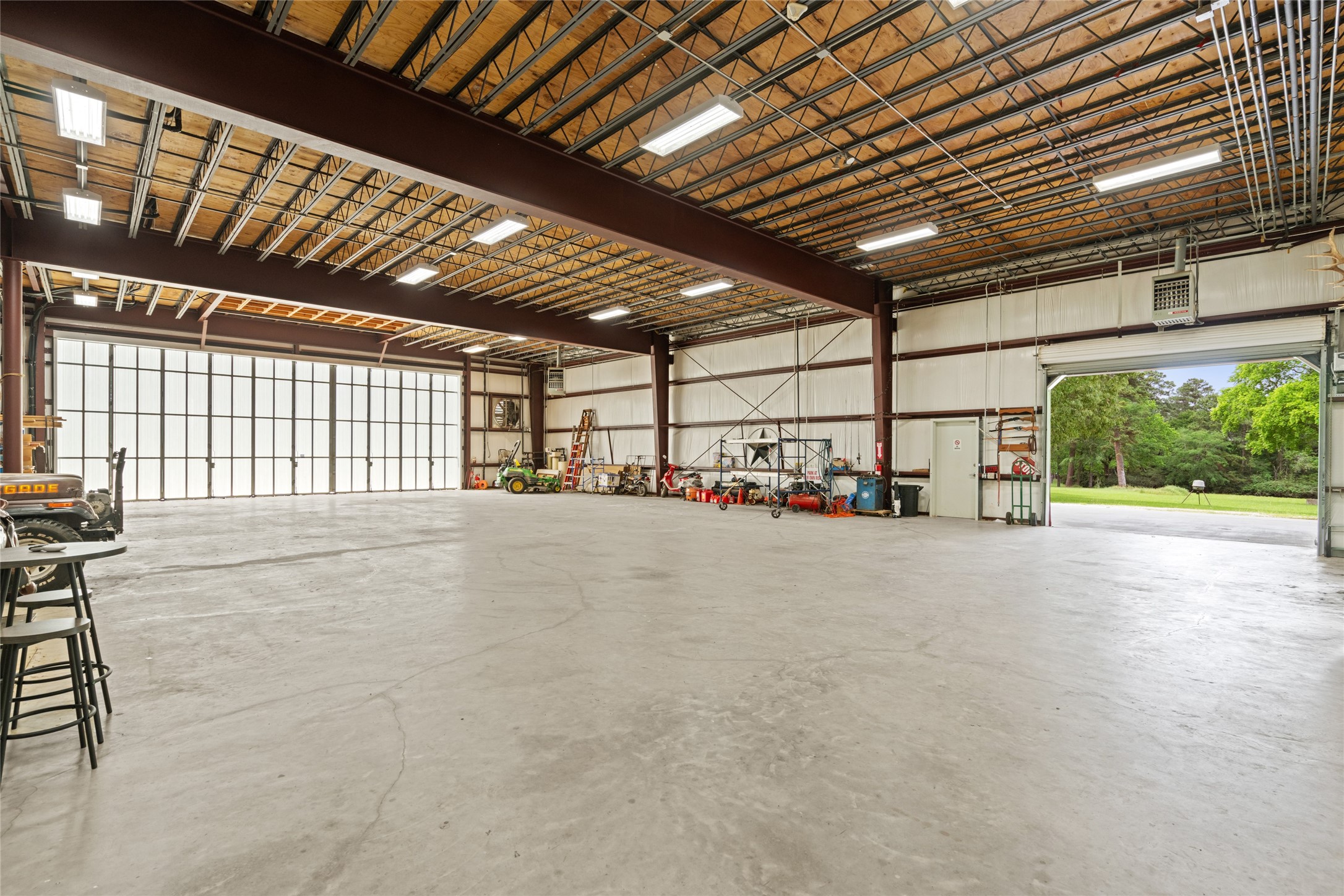 15126 Walden Road Montgomery, TX 77356 - Photo 24 of 50 Robust ground floor workshop/warehouse with numerous access doors, ideal for heavy equipment, vehicles, or hobby projects.