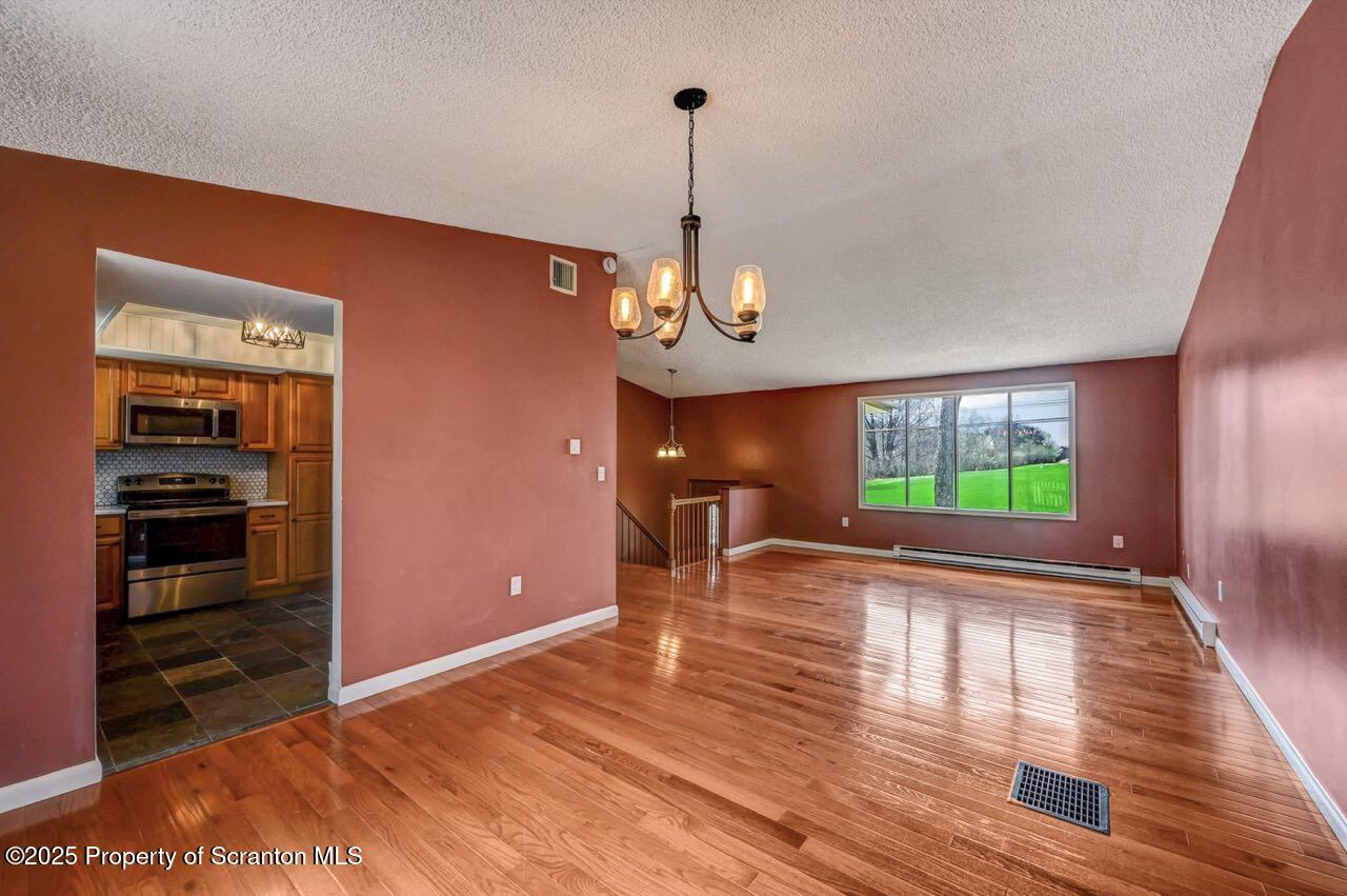219 Noble Road Clarks Summit, PA 18411 - Photo 15 of 47 a view of empty room with wooden floor and fan