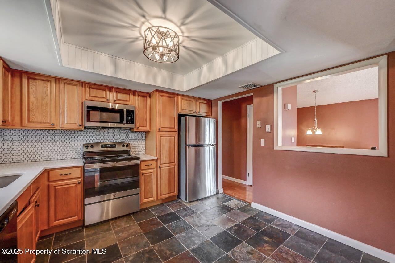 219 Noble Road Clarks Summit, PA 18411 - Photo 16 of 47 a kitchen with stainless steel appliances granite countertop a refrigerator a stove top oven a sink and dishwasher