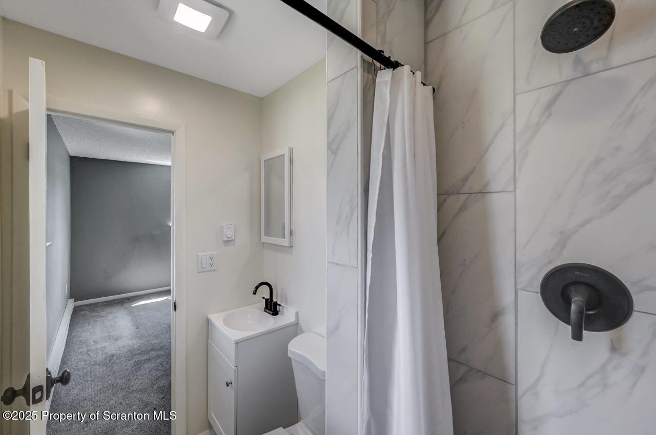 219 Noble Road Clarks Summit, PA 18411 - Photo 22 of 47 a bathroom with a sink a toilet and shower