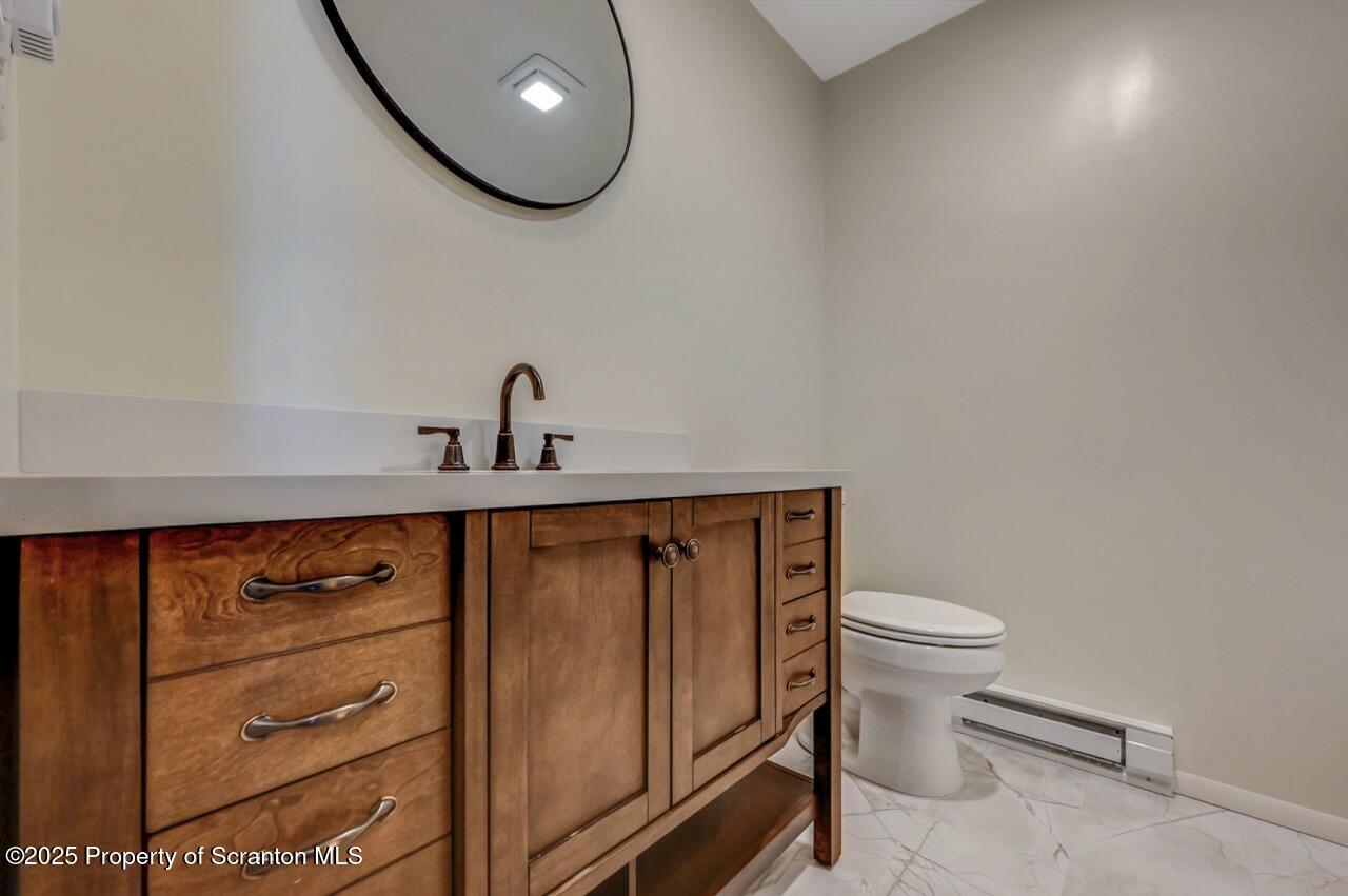 219 Noble Road Clarks Summit, PA 18411 - Photo 23 of 47 a bathroom with a toilet a sink and mirror